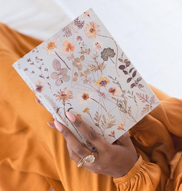 A model holds floral sketchbook