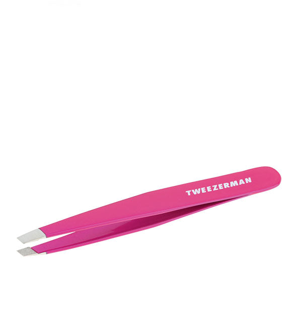 Hot pink tweezer with slanted stainless steel tips and "Tweezerman" logo printed on the handle