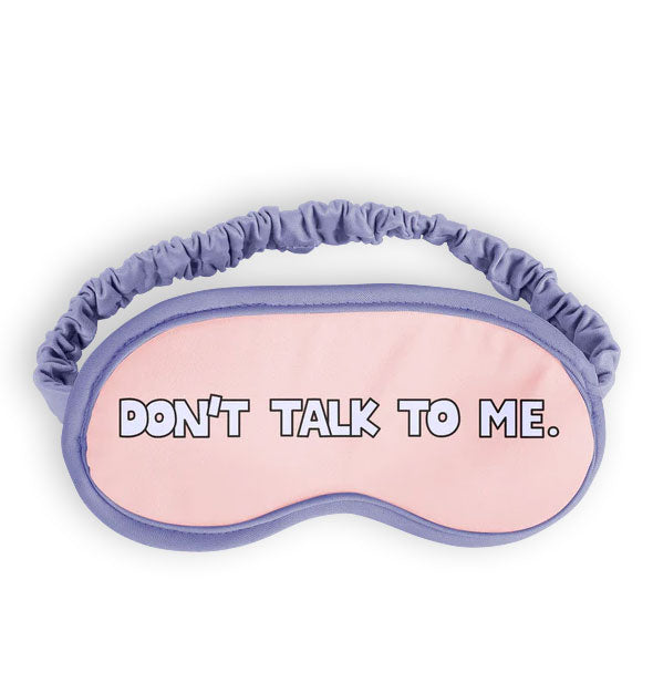 Pink sleep mask with purple piping and ruched elastic band says, "Don't talk to me" in white lettering