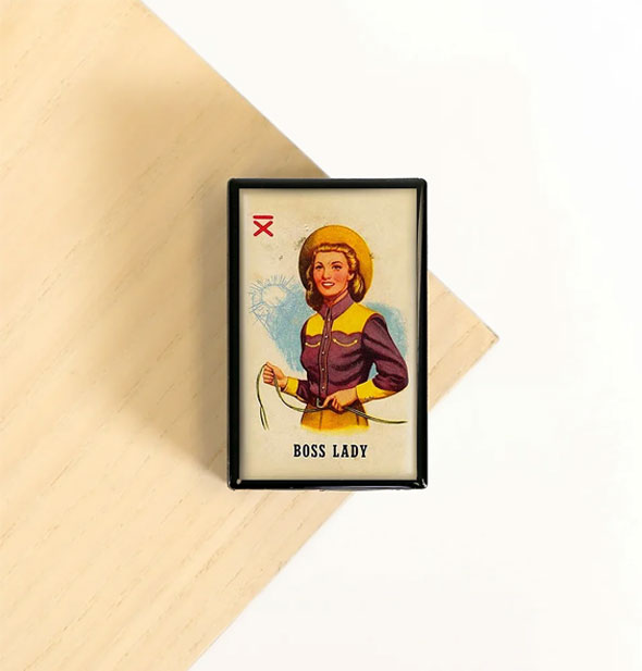 Rectangular box features illustration of a vintage cowgirl above the words, "Boss Lady"