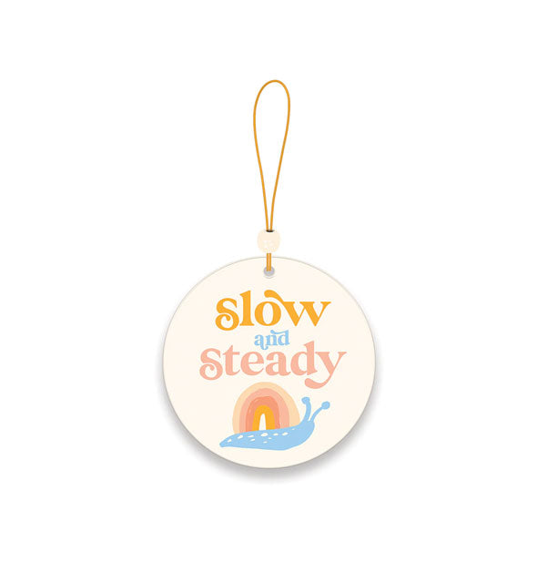 Car air freshener with bead accented elastic strand features rainbow snail illustration with the words, "Slow and Steady"
