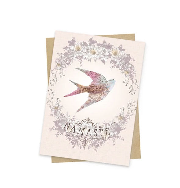 Pale peach greeting card with intricate floral and bird design says, "Namaste" near the bottom