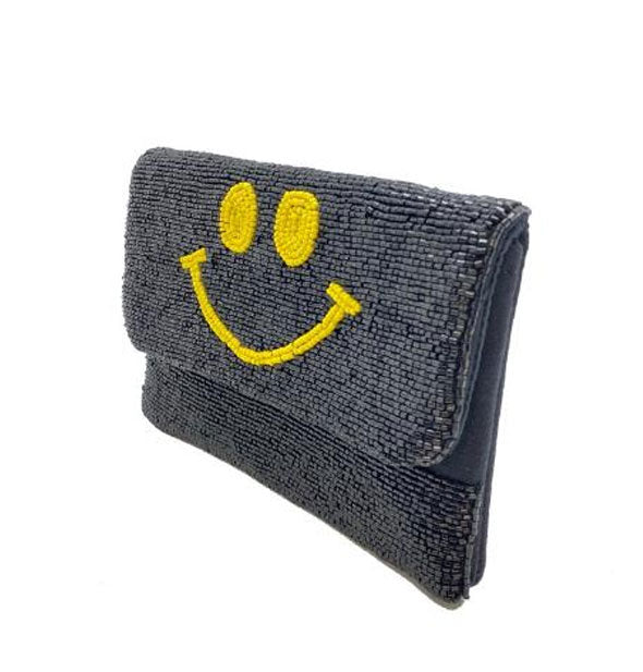 Rectangular black beaded clutch with central yellow smiley face design