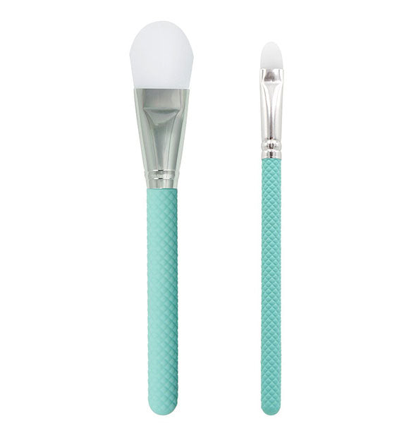 Two applicator/makeup brushes with white bristles and textured teal handles