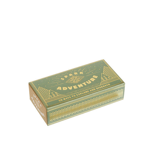 Decorative green and gold Spark Adventure matchbox features design of geometric mountains and trees