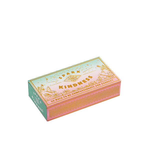 Decorative pink and green Spark Kindness matchbox with gold lettering and illustrations of flowers and butterflies