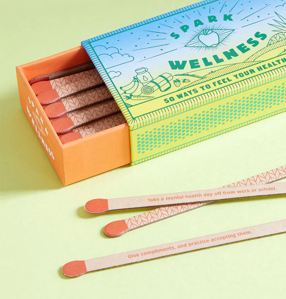 Faux matchsticks printed with geometric patterns and prompts to Spark Wellness