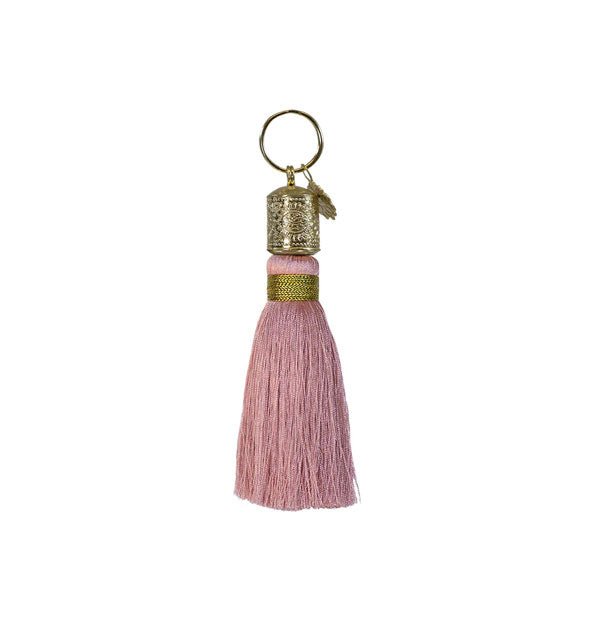 Muted pink tassel keychain with decorative gold hardware