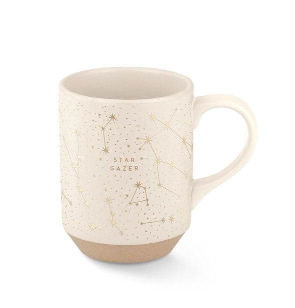 Cream-colored coffee mug with tapered matte brown stoneware base says, "Star Gazer" in gold amid an all-over constellation design