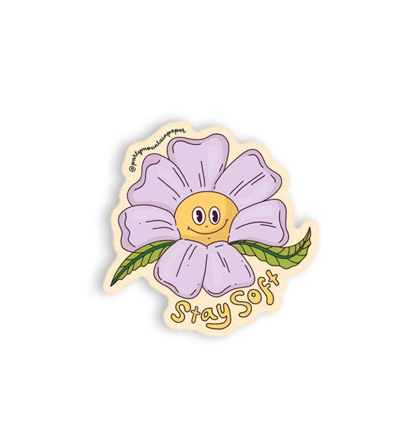 Sticker with illustration of a purple flower with green leaves and a yellow, smiling center says, "Stay Soft" in yellow bubble lettering