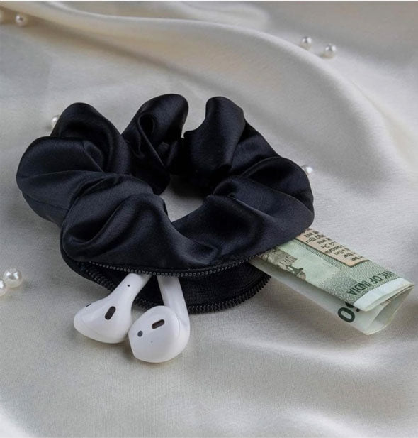 Black hair scrunchie features a zippered storage pocket big enough for earphones and money to fit inside