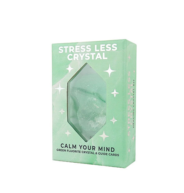 Green Stress Less Crystal kit box with metallic silver design elements and window through which a green fluorite crystal is visible inside