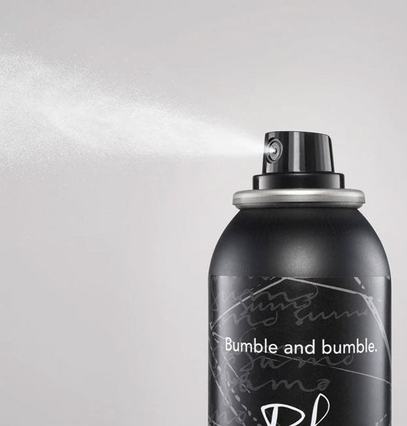 A fine mist is dispensed from a can of Bumble and bumble Sumo Liquid Wax + Finishing Spray