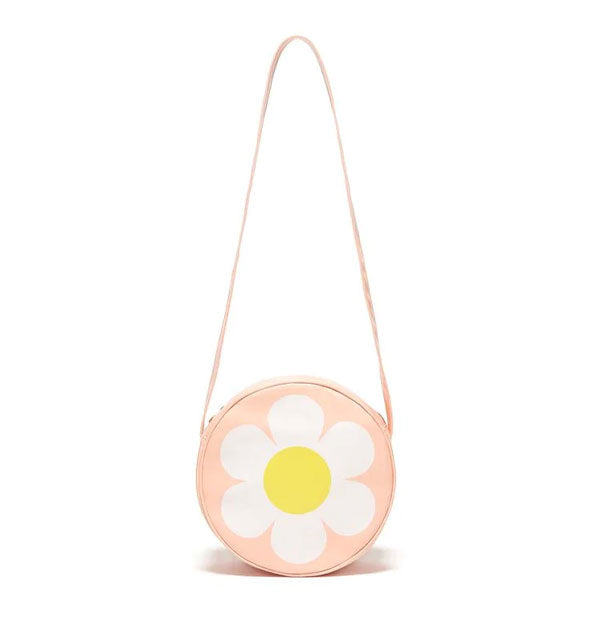 Round peach-pink bag with long strap features a central yellow and white flower design
