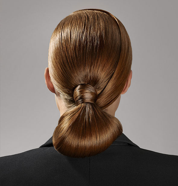 Structural, slicked-back hair is styled with Oribe Superfine Strong Hairspray