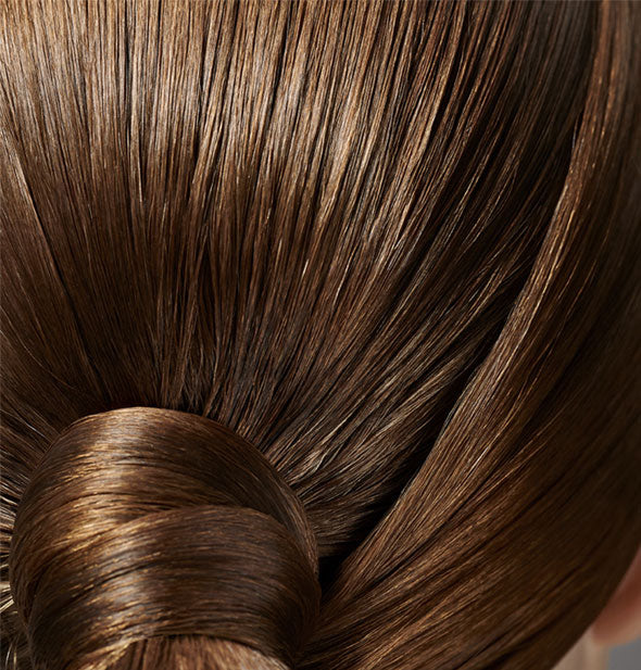 Closeup of structural, slicked-back hair that is styled with Oribe Superfine Strong Hairspray