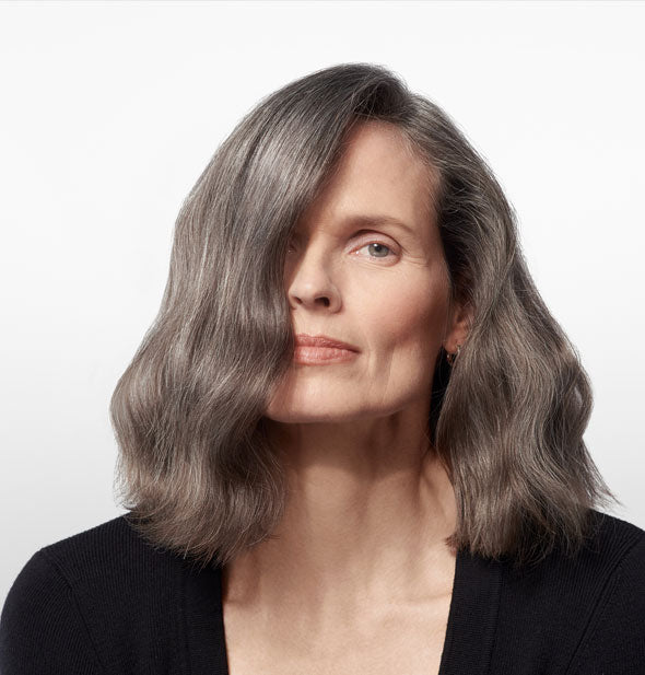 Shoulder-length gray hair is styled with Oribe Supershine Moisturizing Cream