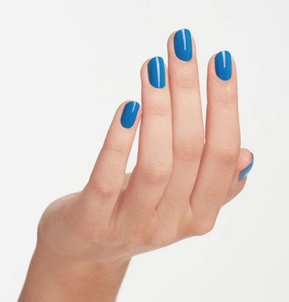 Model's hand wears a bright blue shade of nail polish