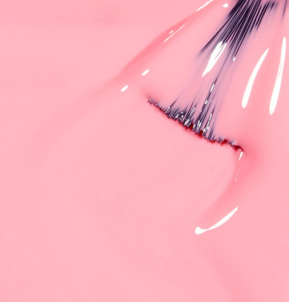 Bubblegum pink nail polish with brush tip dipped in it