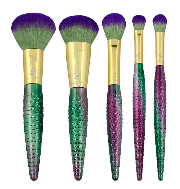 Five makeup brushes with purple-to-green ombré handles that look like fish scales, gold ferrules, and green-to-purple ombré bristles