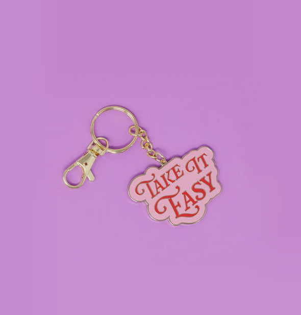 Pink enamel keychain with gold hardware says, "Take It Easy" in red lettering