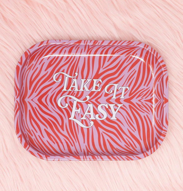 Rectangular tray with rounded corners and a pink and red zebra stripe print says, "Take It Easy" in white lettering