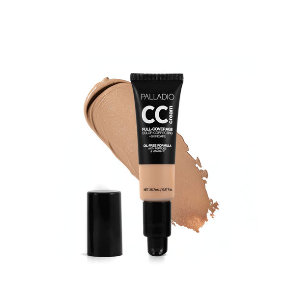 Tube of Palladio CC Cream Full-Coverage Color Correcting +Skincare in a medium-dark cool shade with cap removed sample swatch behind