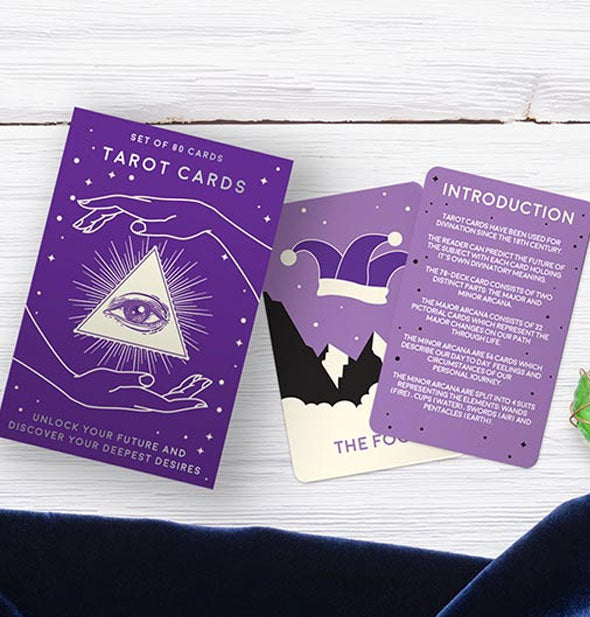 Sample Tarot Cards with box on a white wooden surface