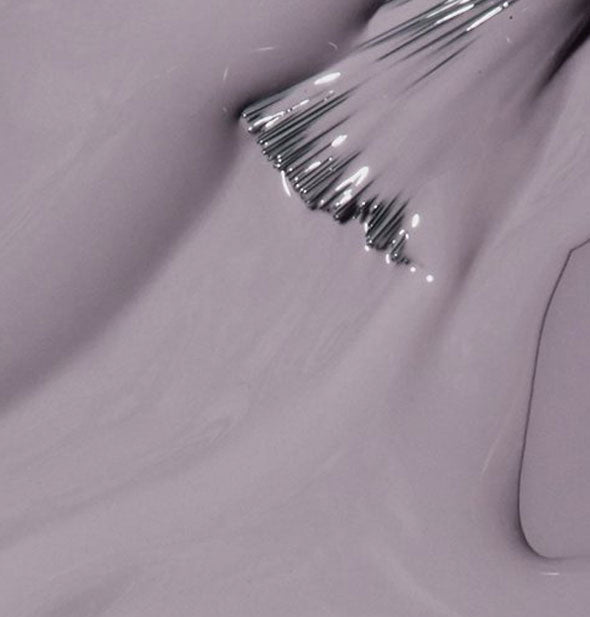 Gray-ish purple nail polish with a brush tip swiped through it