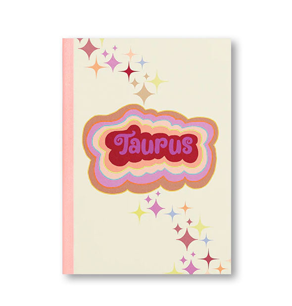 Notebook cover with pink binding, colorful stars, and colorful radiant lettering that reads, "Taurus"
