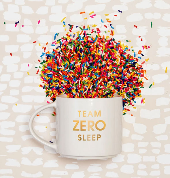 Team Zero Sleep mug with colorful sprinkles spilling out of it