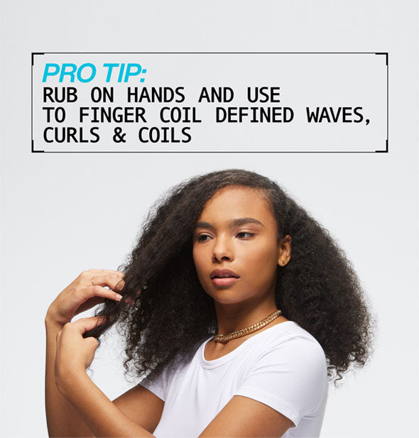 Model demonstrates use of Redken Texture Paste under the caption, "Pro Tip: Rub on hands and use to finger coil defined waves, curls & coils"