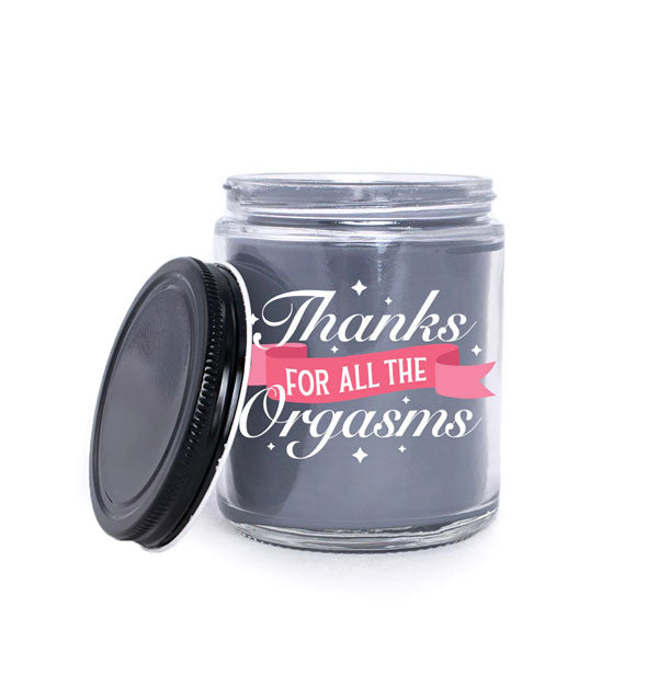 Dark wax jar candle with black lid says, "Thanks for all the orgasms" in white lettering that incorporates a pink banner graphic
