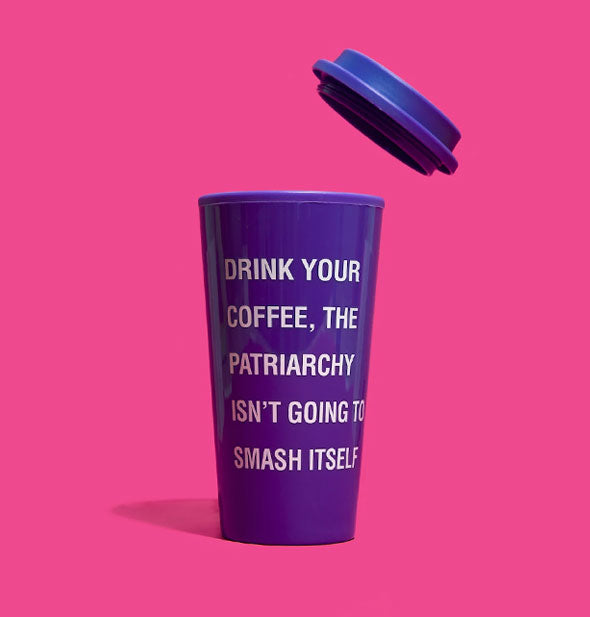 Purple travel mug on pink background with matching floating above says, "Drink your coffee, the patriarchy isn't going to fight itself" in light lettering