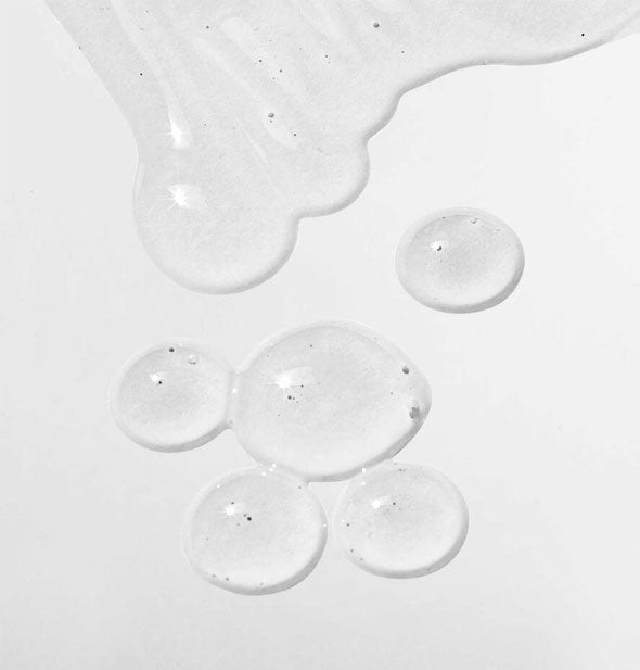 Sample droplets of Mizani Therasmooth Shine Extend spray