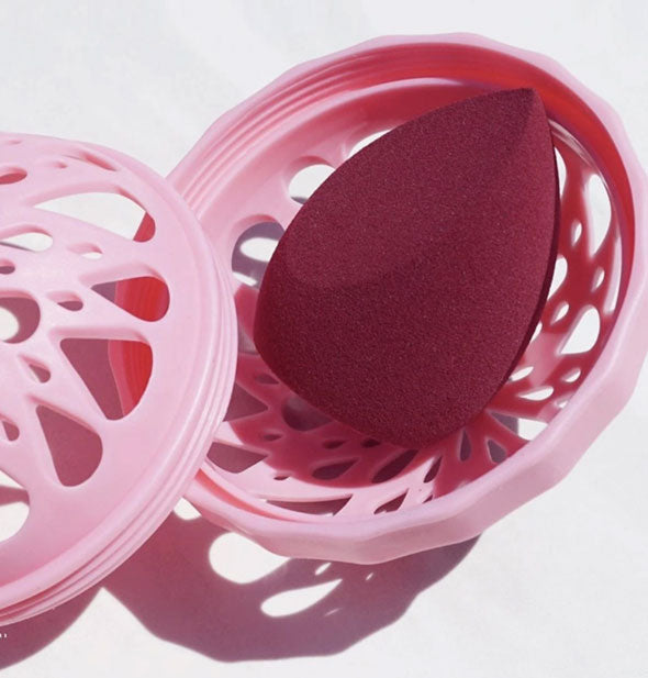 The Sponge by Makeup Eraser shown with its pink machine washable cage