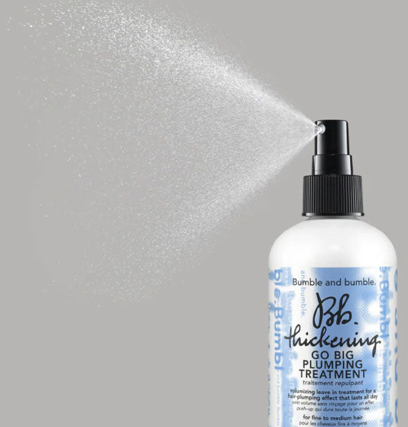 A fine mist is dispensed from a bottle of Bumble and bumble Thickening Go Big Plumping Treatment