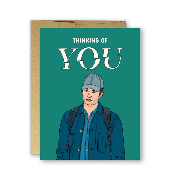 Teal greeting card with illustration of the Netflix show character Penn Badgley says, "Thinking of YOU" in white lettering at the top