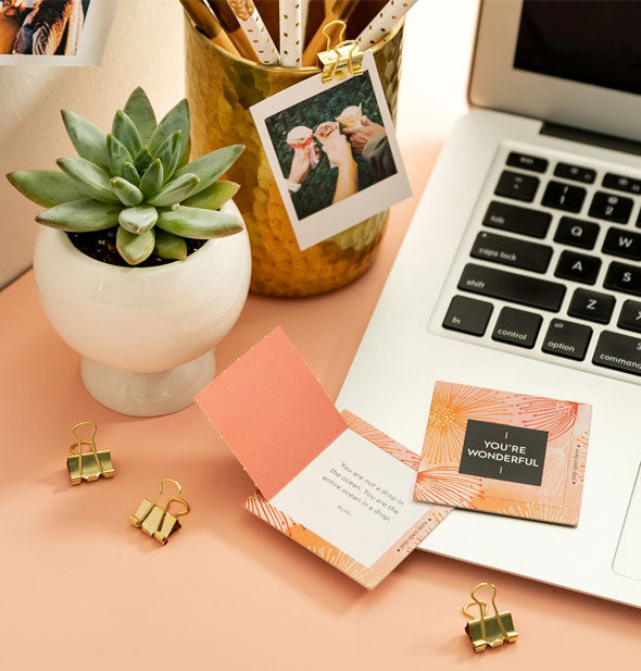 You're Wonderful pop-up cards on an office desktop with paper clips, succulent, pencil cup with Polaroid attached, and laptop
