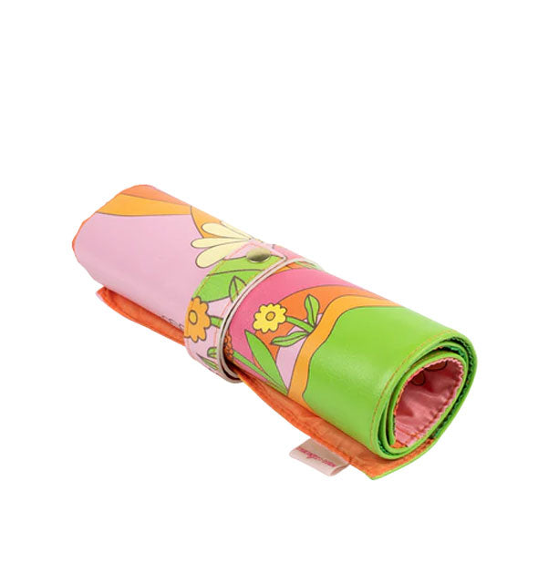 Retro-style colorful flower print pouch roll secured with a gold snap