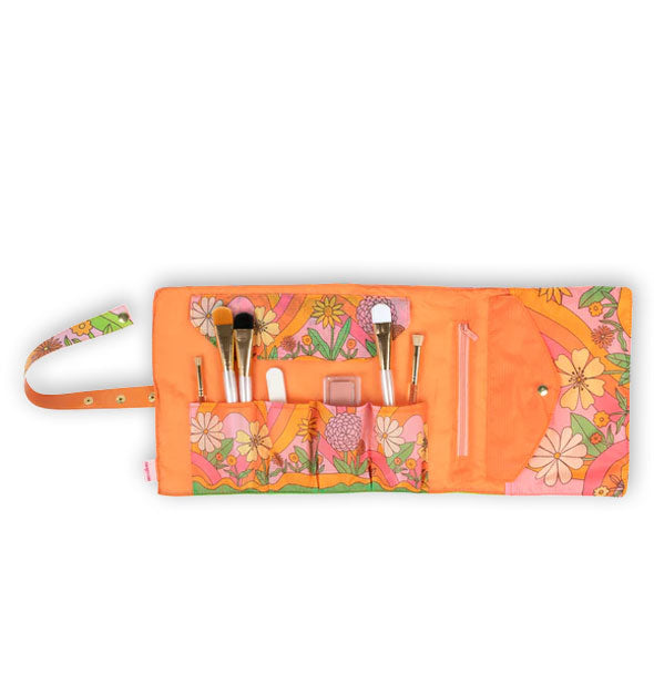 Orange brush roll pouch interior with floral accents, pockets, and left-hand strap