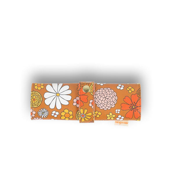 Brown roll pouch with retro-style floral print is secured with a gold snap