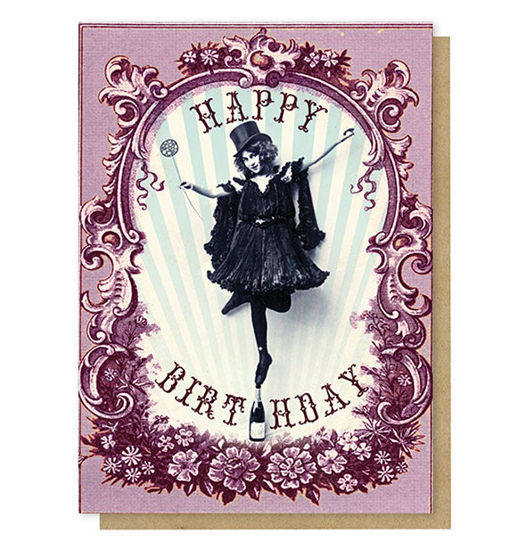Purple greeting card features illustration of a girl in top hat balancing on tip-toe on top of a champagne bottle inside an ornate border with the words, "Happy Birthday"