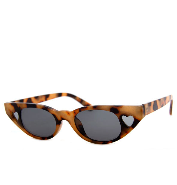 Tortoise sunglasses with heart cut-outs on either side of front frame