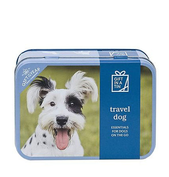A rectangular tin with rounded corners features a picture of a terrier and print that reads, "Travel Dog: Essentials for Dogs on the Go."