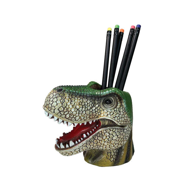 Green Tyrannosaurus rex head pencil cup holds several black pencils with colorful erasers