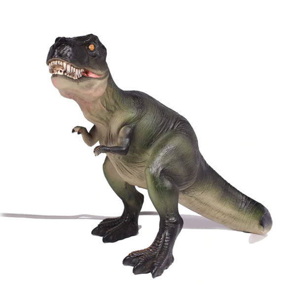 Tyrannosaurus rex figurine lamp with cord extending off to the left