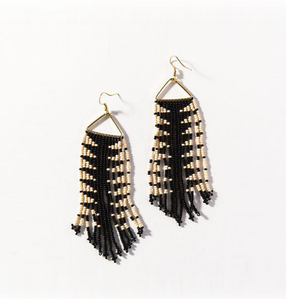 Pair of black and white triangle-print fringe dangle beadwork earrings on gold hardware