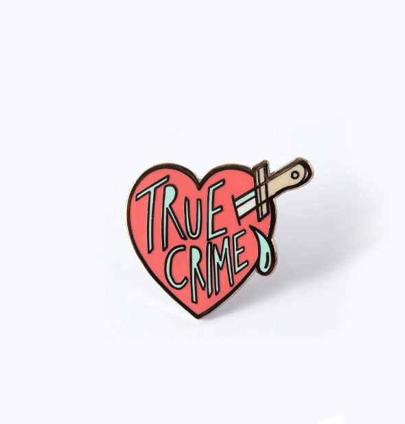 Pink enamel stabbed heart pin says, "True Crime"