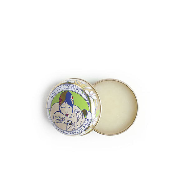 Opened round tin of waxy white vanilla Gala Collection lip balm features a turn-of-the-century illustration of a woman applying a cosmetic